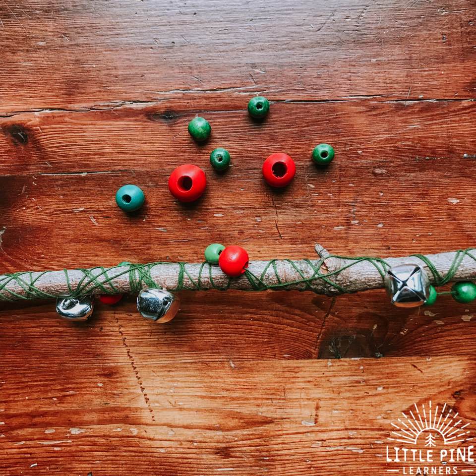 Once all of your beads and bells are on the string, you can wrap it around the branch the same way as before. You might need to move the beads and bells to space them out. Also make sure you tightly wrap the string around the branch or you will need to tighten it later.