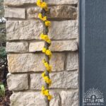 Here's a fun hiking accessory that will keep kids moving and exploring on the hiking trail. Try this activity when you want to get your kids outdoors in the spring. These dandelion hiking sticks are super easy to make and look beautiful when complete!