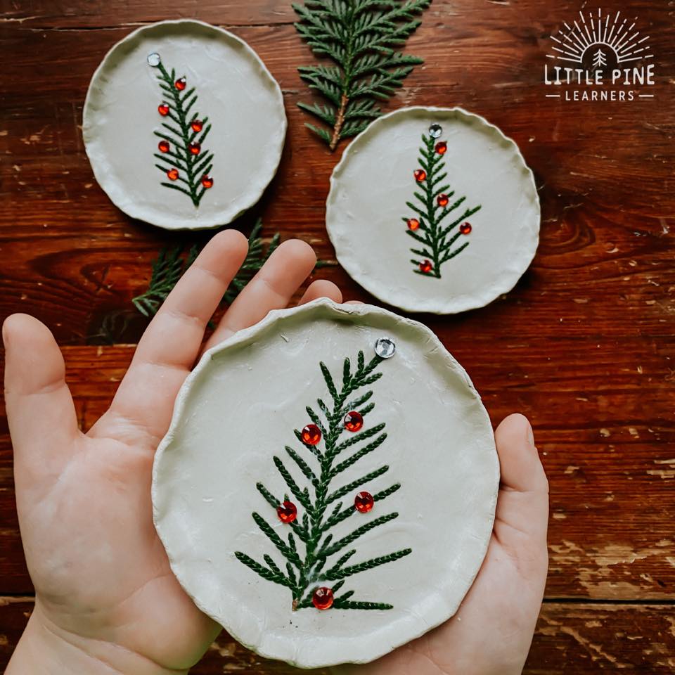 Clay dish with evergreen pieces.