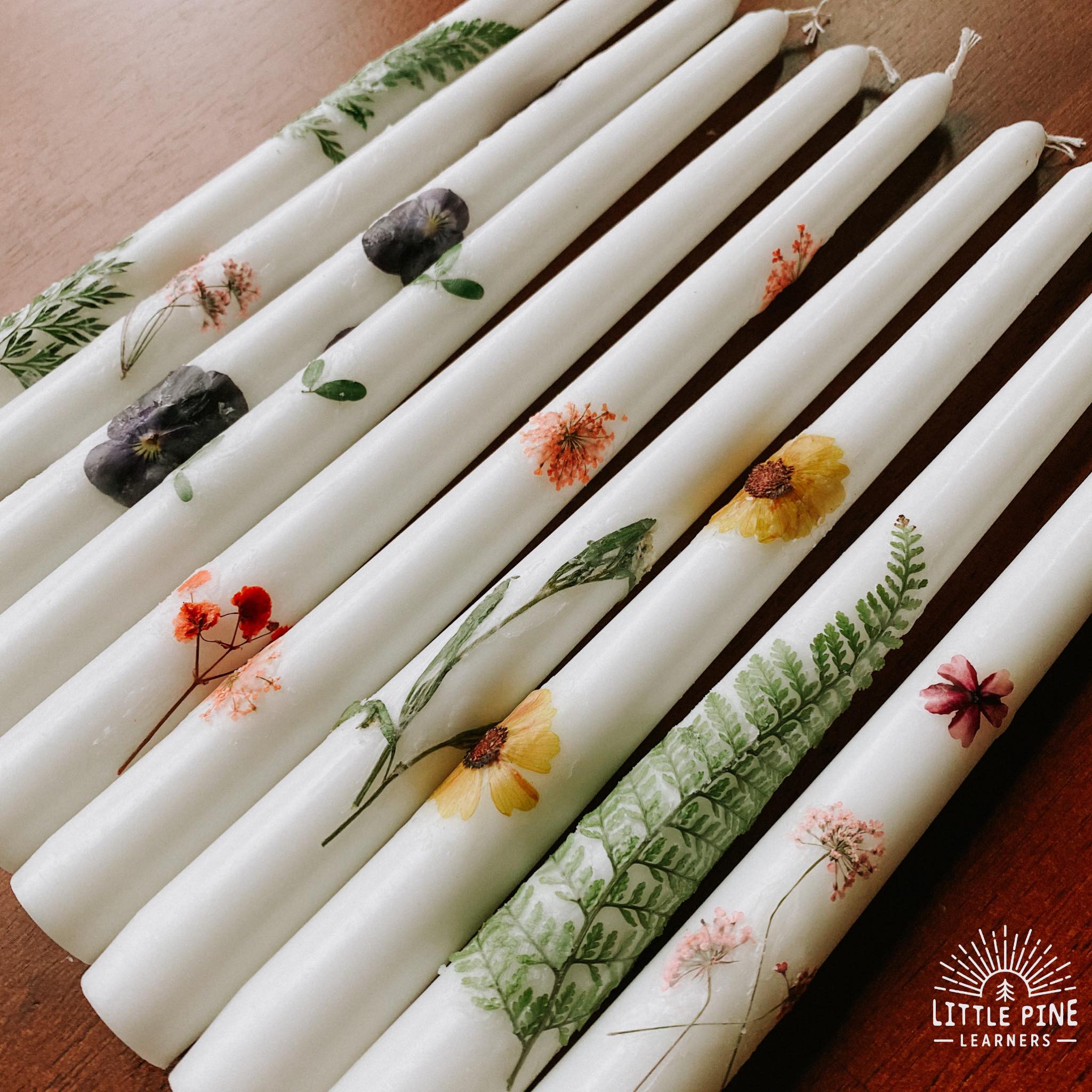 White taper candles with pressed flowers